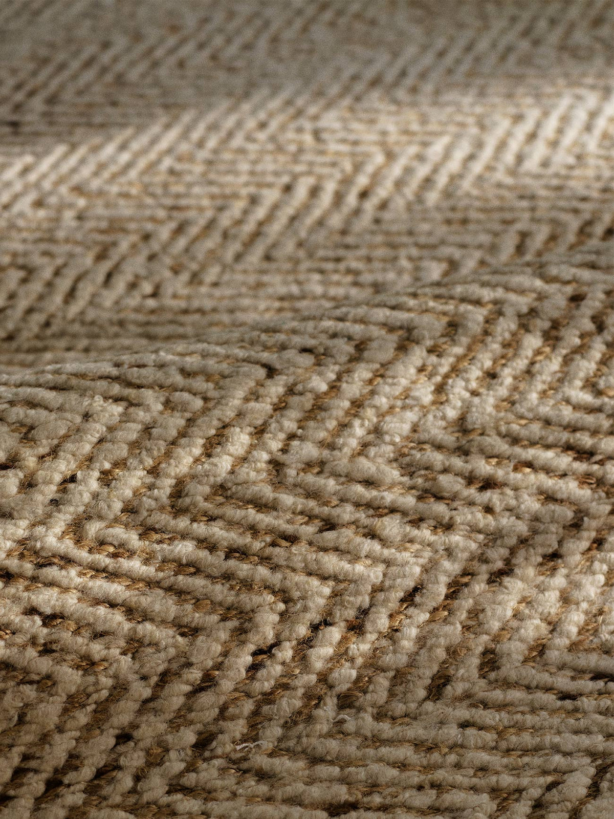 Close-up of a woven rug with a herringbone pattern in natural beige and light brown tones | Armadillo Pinnacle Rug